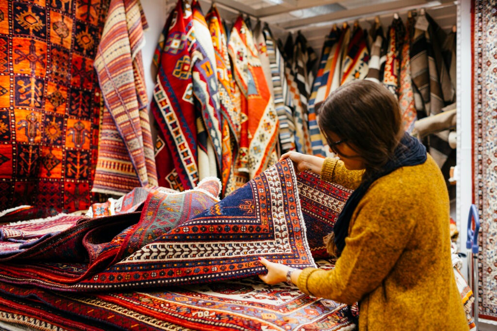 Young Woman Shopping For Rugs In